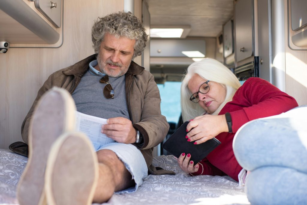 older couple on iPad in camper van symbolising secure and connected living